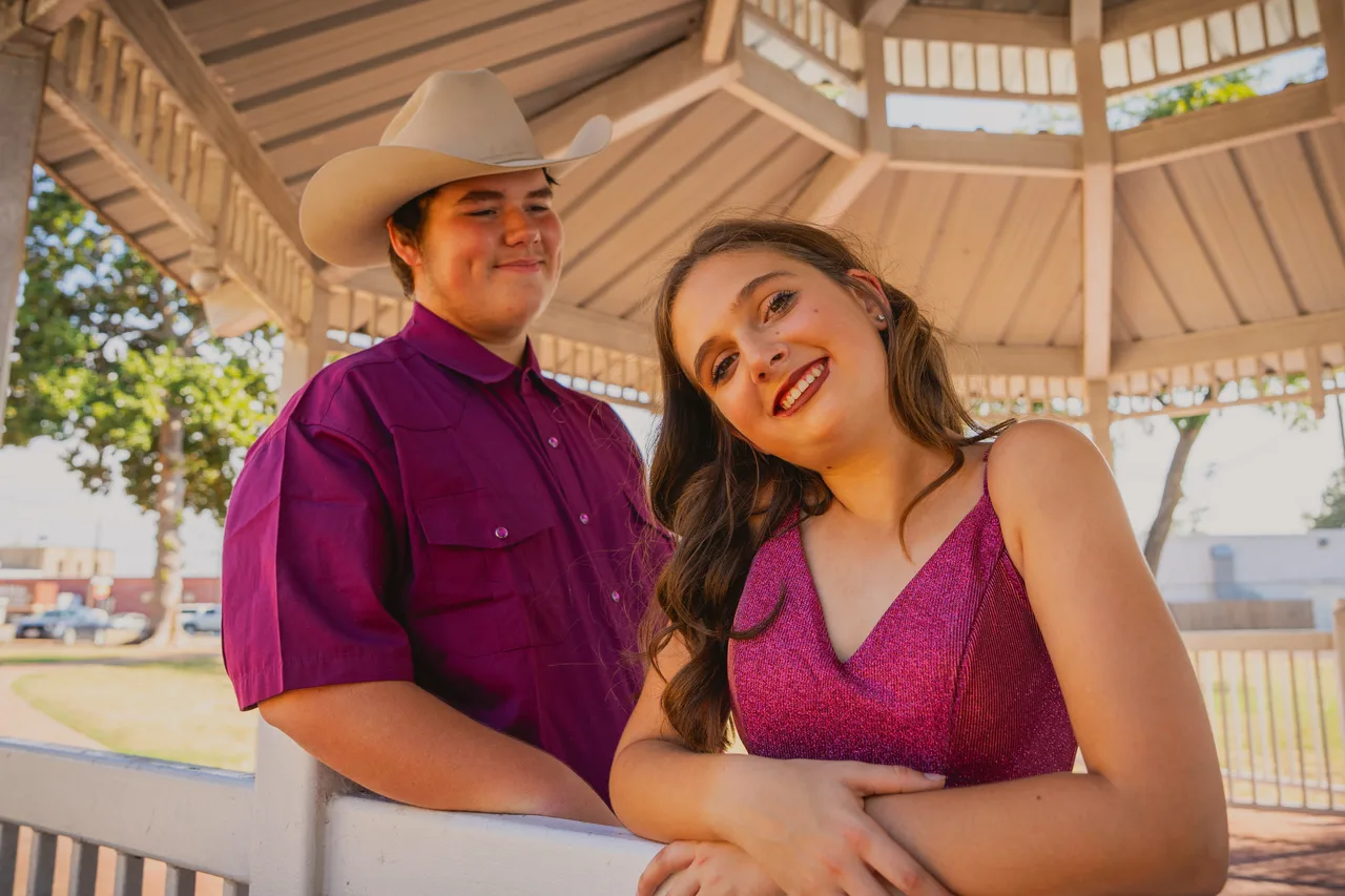 A couple leaning on a gazebo railing