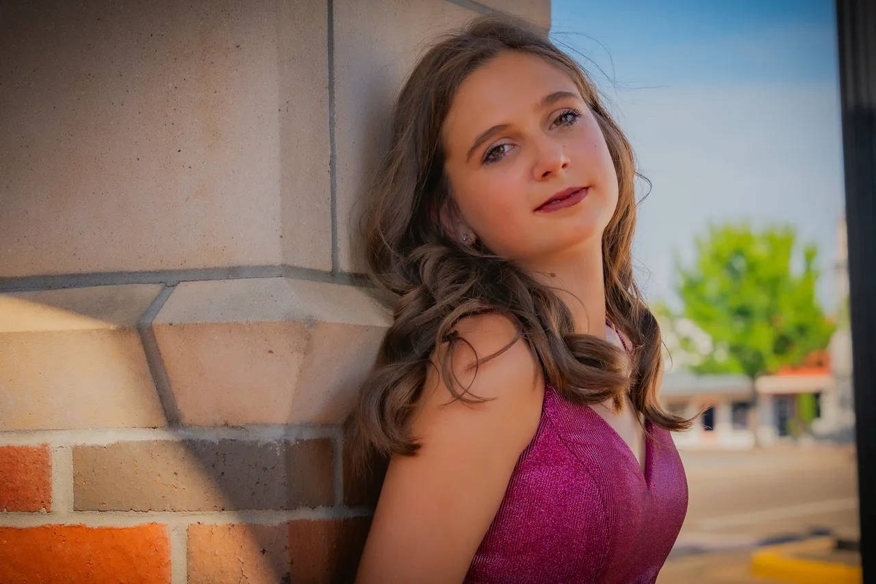 A portrait leaning against a brick and stone wall downtown