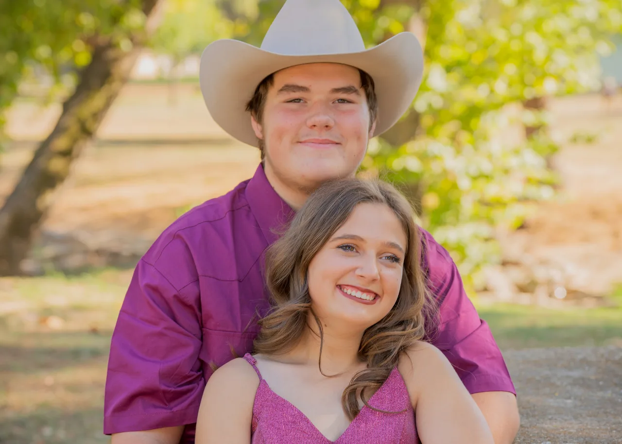 A classic smiling portrait of a couple in a park