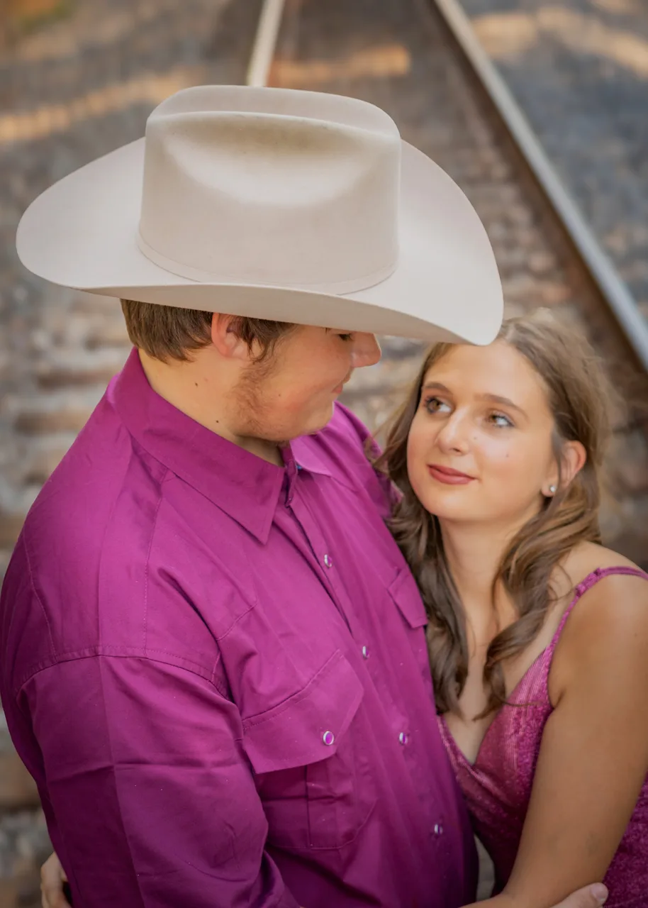 A quiet moment, her looking up at him under his hat